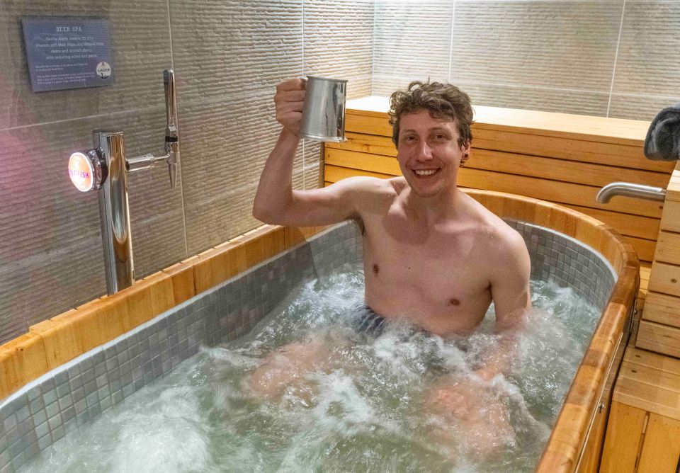 Sun man Josh Saunders raises a glass to readers at the UK's first beer spa