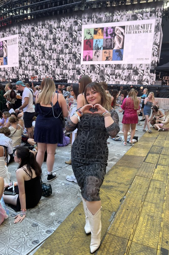 Metro reporter Danni Scott at Taylor Swift gig, posing with heart hands symbol in Reputation inspired dress