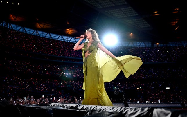 Taylor Swift wears green dress as she sings folklore and evermore eras during Eras Tour 