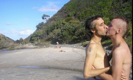 The couple kiss on the sand