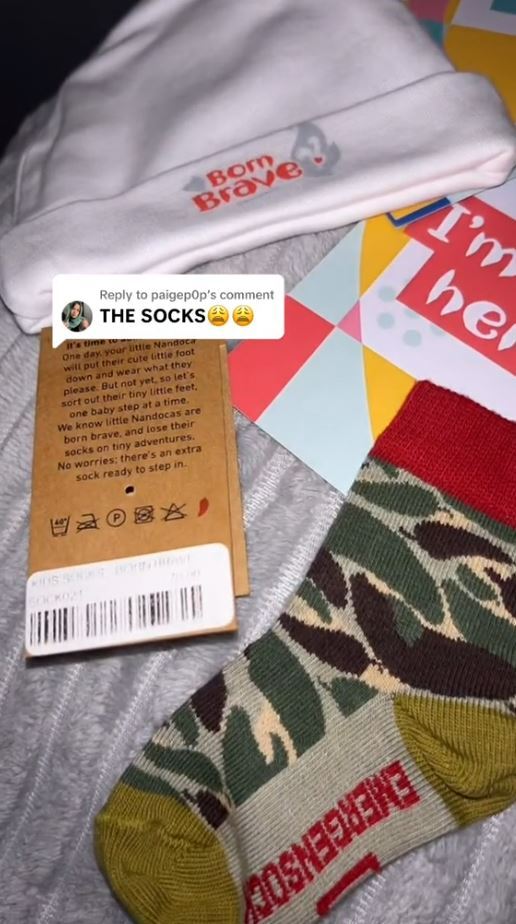 El recieved socks, a babygrown, milestone cards and a babyhat