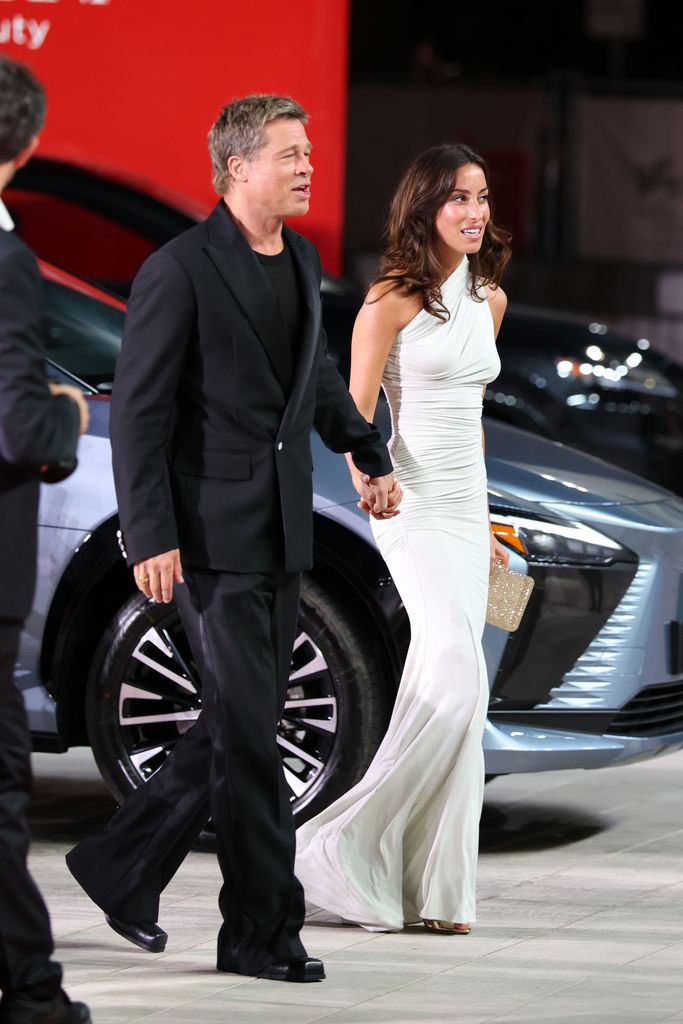 Brad Pitt and Ines de Ramon attend the "Wolfs" red carpet during the 81st Venice International Film Festival 