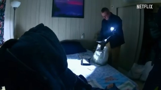 A man holding a bag on a bed in Netflix documentary Worst Ex Ever