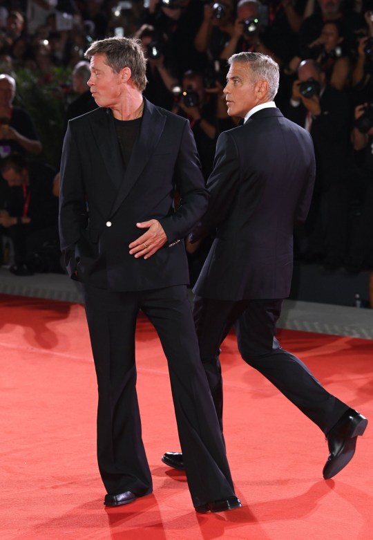 Brad Pitt and George Clooney pose at the 'Wolfs' premiere at the 81st Venice International Film Festival