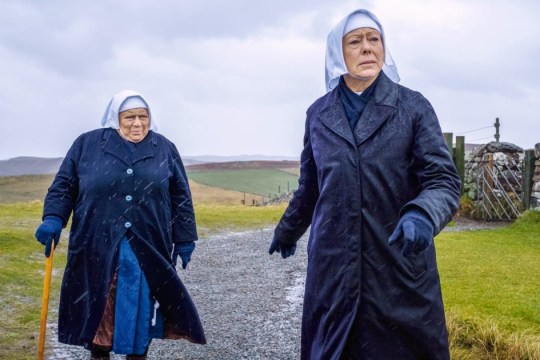 Miriam Margolyes as Sister Mildred and Jenny Agutter as Sister Julienne walking down a country road in the rain on Call The Midwife