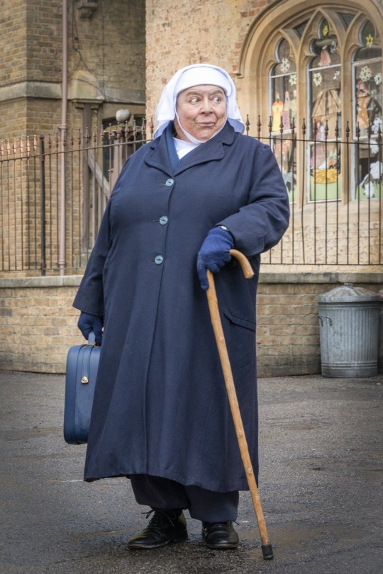 Miriam Margolyes as Sister Mildred using a cane outside a church on Call The Midwife