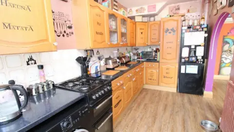 Elwy Estates A kitchen with Disney song titles emblazoned on its cupboards