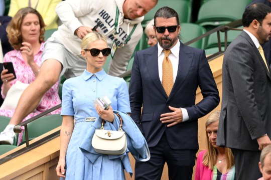 Dave Grohl and Jordyn Blum walking out of a match at Wimbledon 2024 