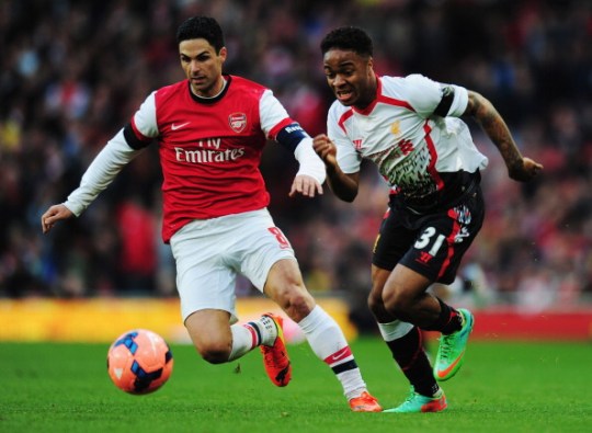 Raheem Sterling (R) of Liverpool holds off the challenge of Mikel Arteta (L) of Arsenal during the FA Cup Fifth Round match between Arsenal and Liverpool at the Emirates Stadium 