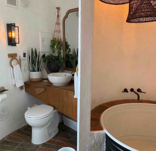 Inside the Silo at Big Idaho Potato Hotel, showing a white toilet, a wooden unit with sink, and a tub