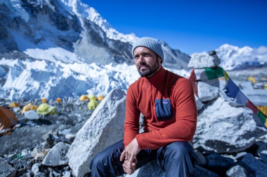 Spencer Matthews sitting around Mount Everest with hat and fleece on 