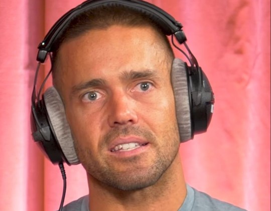 Spencer Matthews with headphones on looking emotional