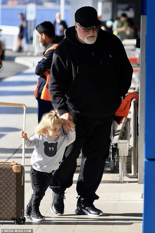 Kyle's son Otto was sweetly seen helping to push their Louis Vuitton suitcase as they were dropped off at the airport