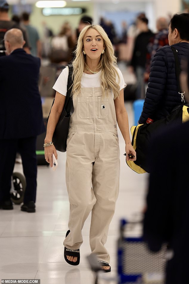 Jackie accessorised her look with an array of chunky gold jewellery and styled her golden tresses in loose waves across her shoulders