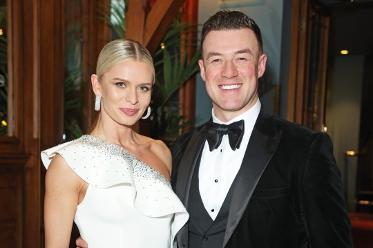 Nadiya Bychkova and Kai Widdrington smile for a photo in their black tie attire