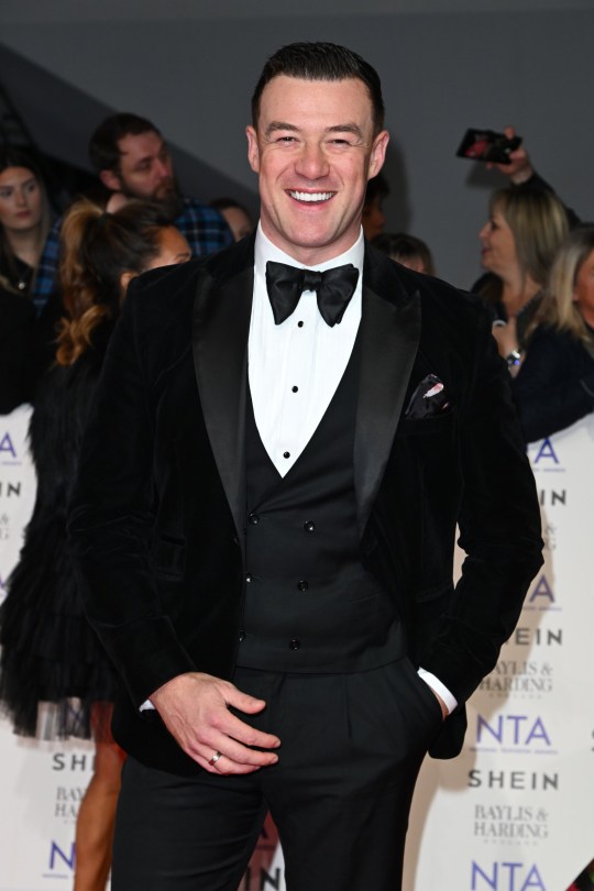 Kai Widdrington attends the NTAs 2024 in a black suit with a bow tie