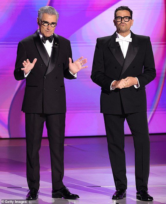 LOS ANGELES, CALIFORNIA - SEPTEMBER 15: (L-R) Hosts Eugene Levy and Dan Levy speak onstage during the 76th Primetime Emmy Awards at Peacock Theater on September 15, 2024 in Los Angeles, California.  (Photo by Kevin Winter/Getty Images)