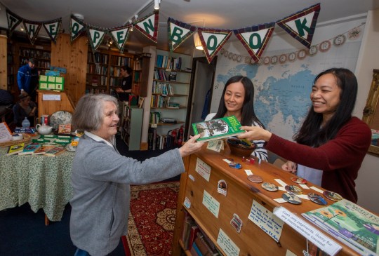 Open Book in Wigtown, Galloway, which can be booked along with it's apartment above and run as a bookshop via AirBnB. Friends Daisy Yeung and Lydia Man from Hong Kong are currently staying in the property and running the bookshop for a week. Photo released September 18 2024. Welcome to the world's only book shop Airbnb where guests spend the night - and run the store in the day.The Open Book a charming bookshop with a flat above so people can sleep upstairs and sell books downstairs.Based in Wigtown - Scotland's National Book Town - it gives book lovers the chance to ''live their dream'' of having their very own shop by the sea.Airbnb say it is ''the first ever bookshop holiday residency experience'' - and is so popular it has a two year waiting list from guests around the globe.