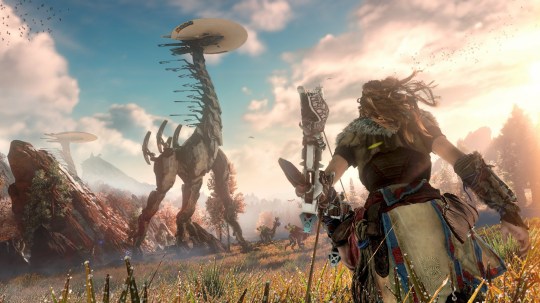 Horizon Zero Dawn screenshot showing a character looking up to the sky at a large dinosaur-like creature 