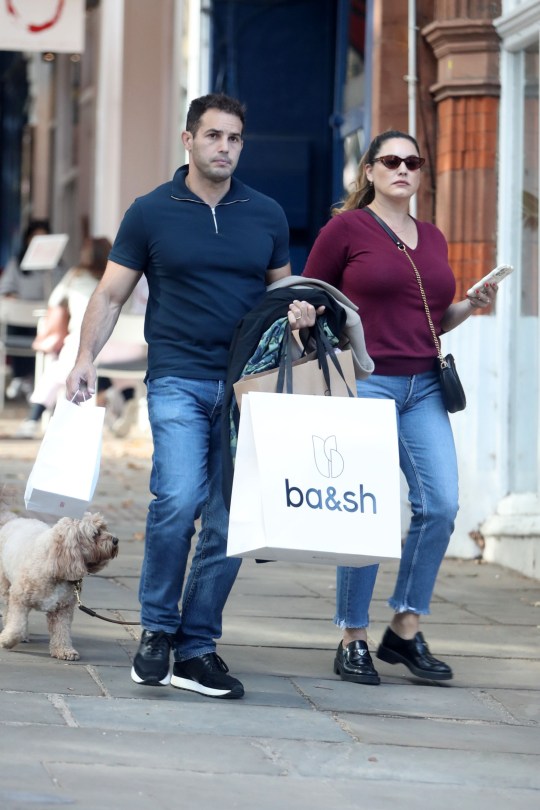 Kelly Brook and her husband walk their dog in a london street