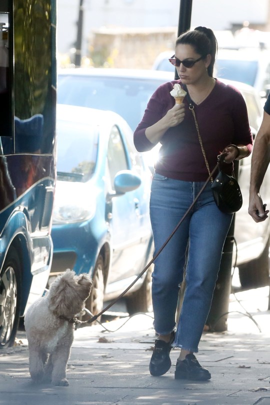 Kelly Brook eats an ice cream during a walk with her dog in London