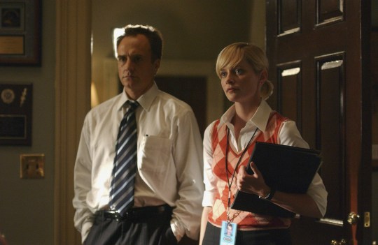 (l-r) Bradley Whitford as Josh Lyman, Kim Webster as Ginger, standing in a doorway looking serious