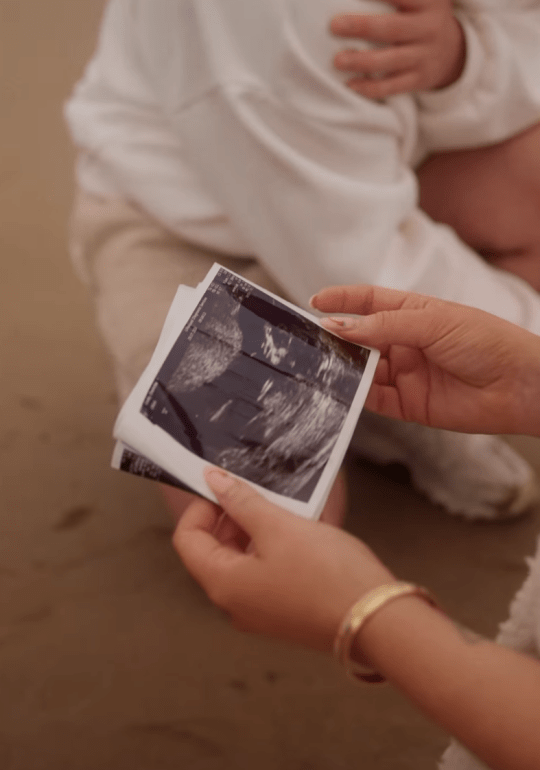 Charlotte Crosby holding ultrasound pictures 