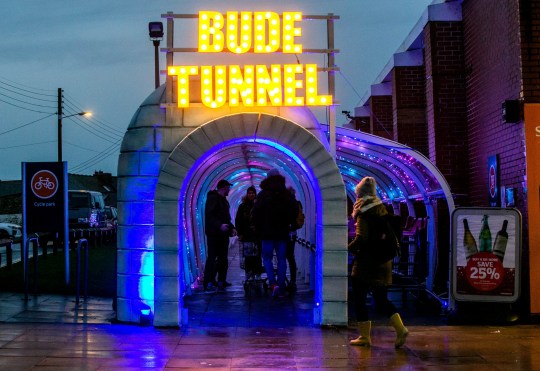 The Bude tunnel which links a Sainsbury???s store in Bude, Cornwall, to its car park has been lit up with thousands of lights. December 7, 2018. See SWNS story SWBRtunnel. Britain???s unlikeliest tourist destination has been given a festive makeover ??? and had a ceremonial switching on of its new Christmas lights. The plastic tunnel linking a Sainsbury???s store in Bude, Cornwall, to its car park has been thrilling visitors this year after unexpectedly topping TripAdvisor???s list of things to do in the seaside town. It???s racked up hundreds of comments with the majority of tongue-in-cheek reviewers rating it as ???excellent???. The 70m (230ft) tunnel has even been compared to the Sistine Chapel and the ruins of Pompeii - and is now first of 51 attractions to visit in the town.