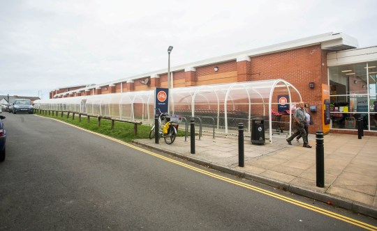 FILE PICTURE - The Bude tunnel next to Sainsbury's in Bude, Cornwall. Release date ??? October 23, 2023, See SWNS story SWLNtunnel. A perspex supermarket tunnel has become one of best reviewed tourist attractions in the UK again after Tripadvisor lifted a ban on comments - imposed when it became too popular. The plastic 70m (230ft) tunnel - which links a Sainsbury's store to its car park - become famous when it became the highest rated attraction in the popualr seaside resort of Bude, Cornwall. People have visited the walkway, dubbed Bude tunnel, from all over the country and some even said it was better than visiting the North Pole. However, TripAdvisor previously suspended reviews about the tunnel, after they said some publicity resulted in a number of not entirely truthful contributions. But they have now turned back on the reviews for the structure and it is back climbing the rankings - currently listed fifth out of the top 34 things to do in the coastal Cornish town.