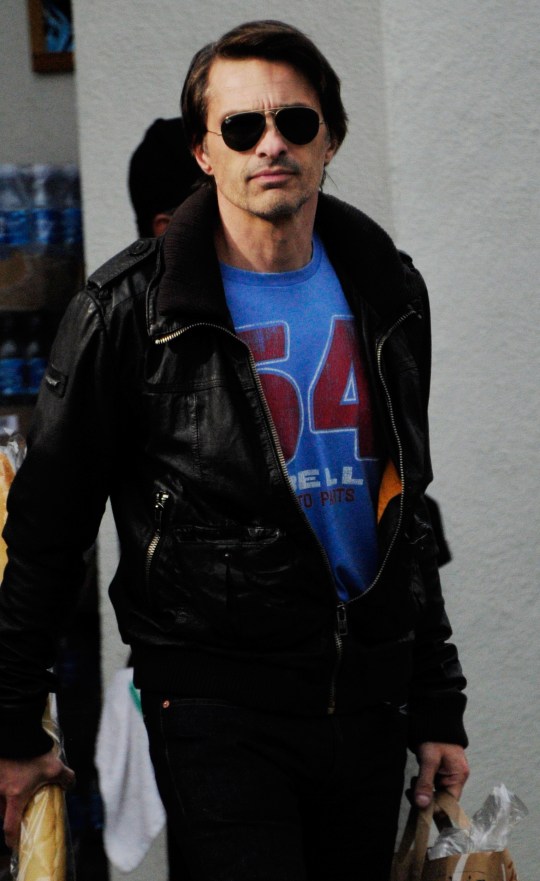 Olivier Martinez wearing a T-shirt, leather jacket and sunglasses