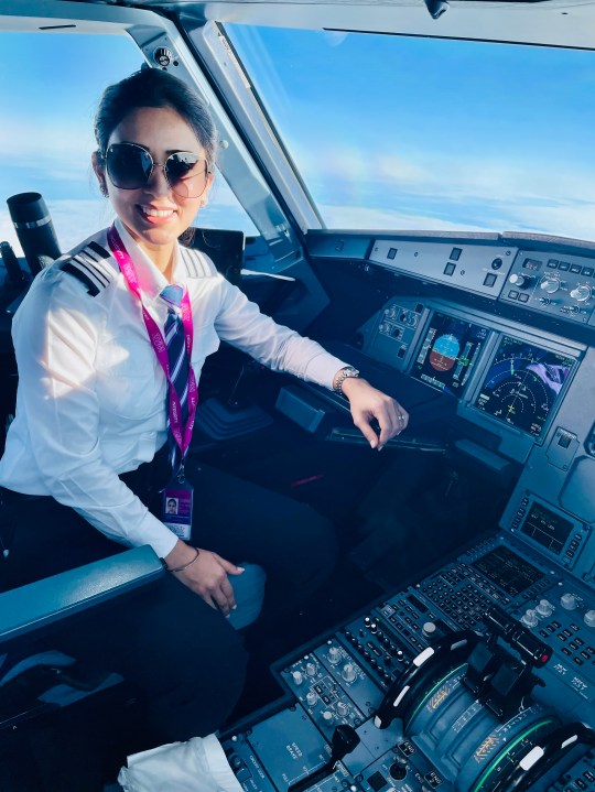 Shibani Kaur Gupta in the flight deck of a plane.