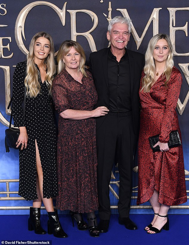 Phillip recalled how a conversation with his daughters Molly, 31, and Ruby, 28, stopped him from going ahead with it (pictured with wife Stephanie Lowe, Molly and Ruby in 2018)