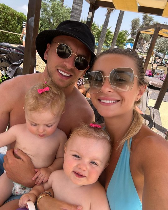 Dani Dyer with partner Jarrod Bowen, holding their twins Summer and Star while on holiday.