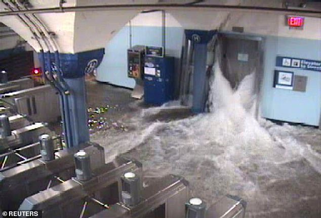 Above, flood waters from Hurricane Sandy in 2012 as they surge into a Port Authority Trans-Hudson (PATH) station connecting New York and New Jersey. The expected arrival of an 'Ultra-​Intense Category 6' would overwhelm this 'intricate substructure of Manhattan,' Fox says