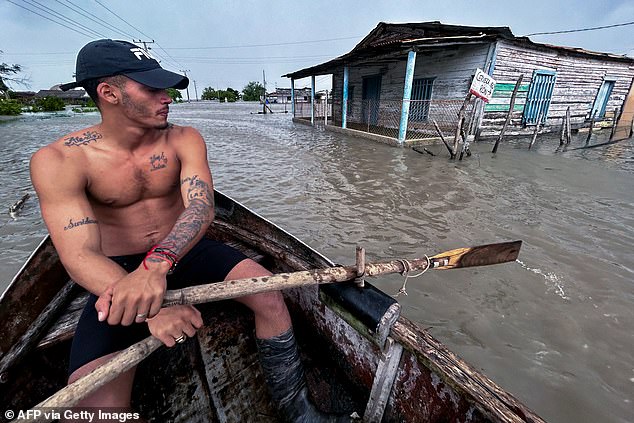 A man rows a boat in flooded streets after Hurricane Helene blitzed Cuba on Sep. 25, 2024. 'Tropical Storm Helene' became a hurricane mid-morning Wednesday in the Gulf of Mexico