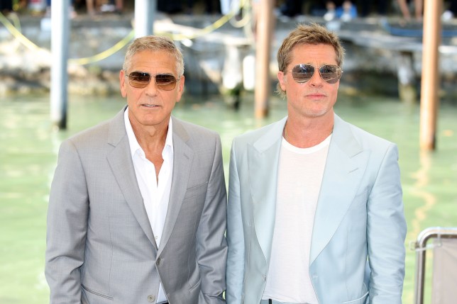 Brad Pitt and George Clooney posing together on the red carpet