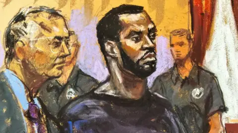 Getty Images Sean "Diddy" Combs and his defense lawyer Marc Agnifilo stand before U.S. Magistrate Judge Robyn Tarnofsky after prosecutors brought three criminal charges against him in federal court in the Manhattan borough of New York City, U.S., September 17, 2024 in this courtroom sketch.