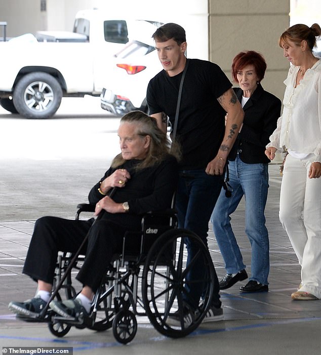 The 75-year-old rocker was pushed in a wheelchair before getting up and using a cane to walk