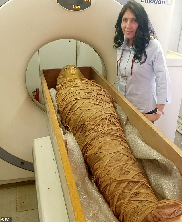 Dr Sahar Saleem, a professor of radiology at the Faculty of Medicine at Cairo University where she works on the Egyptian Mummy Project, stands beside the mummified body of the Egyptian Pharaoh Amenhotep I as it was digitally 'unwrapped' with high-tech scanners back in 2021