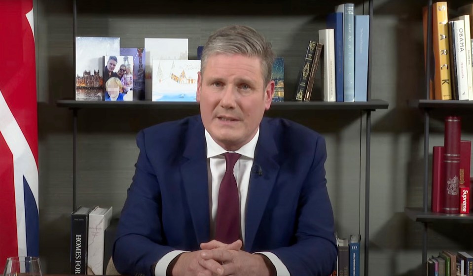 Keir Starmer addresses the nation in the borrowed flat —  complete with family photograph on the shelf — making it look like his own home