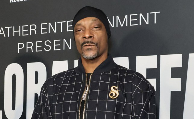 Snoop Dogg wearing a black and white chequered jacket and black head wrap