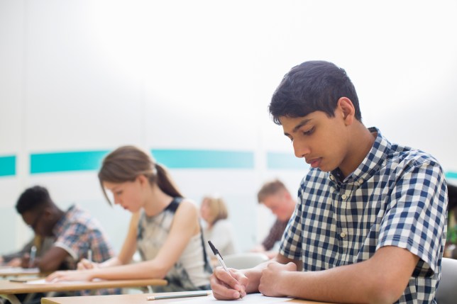 Students taking examinations in classroom