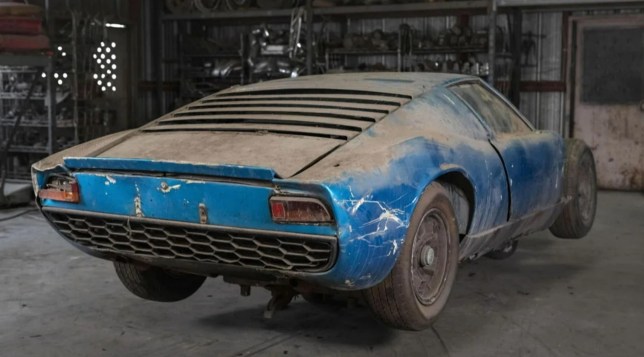 Back of blue car. CALIFORNIA, USA: THREE FORGOTTEN Lamborghini Miuras found in a junkyard are heading to auction for ??1.5m. Pictures show three examples of what is considered to be the world???s first supercar, covered in dust, at a junkyard belonging to renowned collector Rudi Klein who died in 2001. The cars will be auctioned at the end of October through RM Sotheby???s. This is one of the world???s most secret car collections, which is for the first time being auctioned off by RM Sotheby???s in its ???The Junkyard: The Rudi Klein Collection??? sale. For lovers of Lamborghini???s iconic V-12-engined, Bertone-designed Miura, the auction will include not one, but three restorable examples. One of the most significant examples of the three, is a 1968 Miura P400, believed to have been first owned by Lamborghini engineer and test driver Claudio Zampolli. According to mediadrumworld.com, Zampolli shipped the car to Southern California in the 1970s, with Rudi Klein???s Porche Foreign Auto Wrecking company acquiring the car in 1978. The Miura was initially presented as a rolling chassis at the 1965 Turin Motor Show, drawing considerable customer interest, and four months later a fully clothed prototype was unveiled at the 1966 Geneva Salon. Miura P400 had 350 horsepower and could reach 170 mph and it was built in a modest quantity of just 275 examples through 1970, when it was superseded by the upgraded P400. The car listing is held by RM Sotheby's who commented on the listing. ???Though the Miura would become increasingly powerful with forthcoming iterations, none were as pure and novel as the original P400,??? reads the listing. ???It is, without exaggeration, one of the true paragons of sports car design, and a blue-chip collectible of unanimous merit. ???Originally finished in Giallo Miura over an interior upholstered in Bleu leatherette, this example was specified for the Italian market and equipped with instruments in kilometers. ???The Miura was officially dispatched from the factory to the dealer Lamborcar in March 1968, and the customer of record is listed only as Mr. Zampolli. ???Zampolli also imported Lamborghinis to Southern California, which might explain how this car came into the possession of Rudi Klein by the late 1970s. ???While this is merely conjecture, we know that the Miura was on the premises of Porche Foreign Auto Wrecking by March 1978, as reflected by a handful of dated photo prints on file. ???By then painted in the current shade of bright aqua green, the Miura went into a period of extended storage no shorter than 46 years, from which it now finally emerges. ???For the true purist of automotive archaeology, who would be so bold as to oversee a major rejuvenation, there could hardly be a more inviting prospect.??? mediadrumimages / @RMSothebys