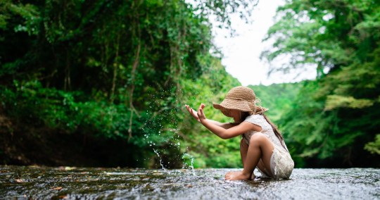 Girl playing in a mountain stream