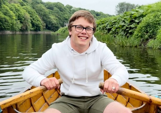 Nathan is seen rowing a boat 