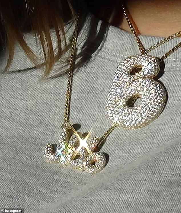 Justin's model wife, 27, recently showed off a diamond-encrusted necklace with their newborn's initials