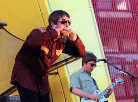 Liam Gallagher sticking his tongue out at fans in crowd 