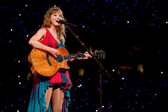 Taylor Swift performs surprise songs onstage during The Eras Tour in Betta Fish dress.