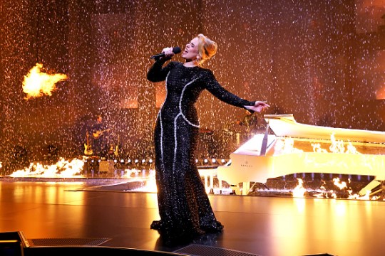 Adele sings onstage in a black and silver dress during Weekends with Adele At The Colosseum At Caesars Palace