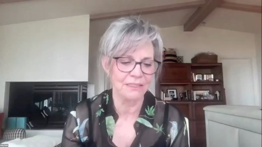 Sally Field wearing a black floral shirt while looking down in a video posted on social media.